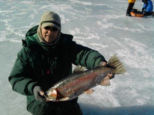 The blog author with a massive 8.5 pound rainbow trout caught through the ice