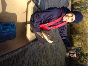 A proud angler showing off his very first brown trout ever!